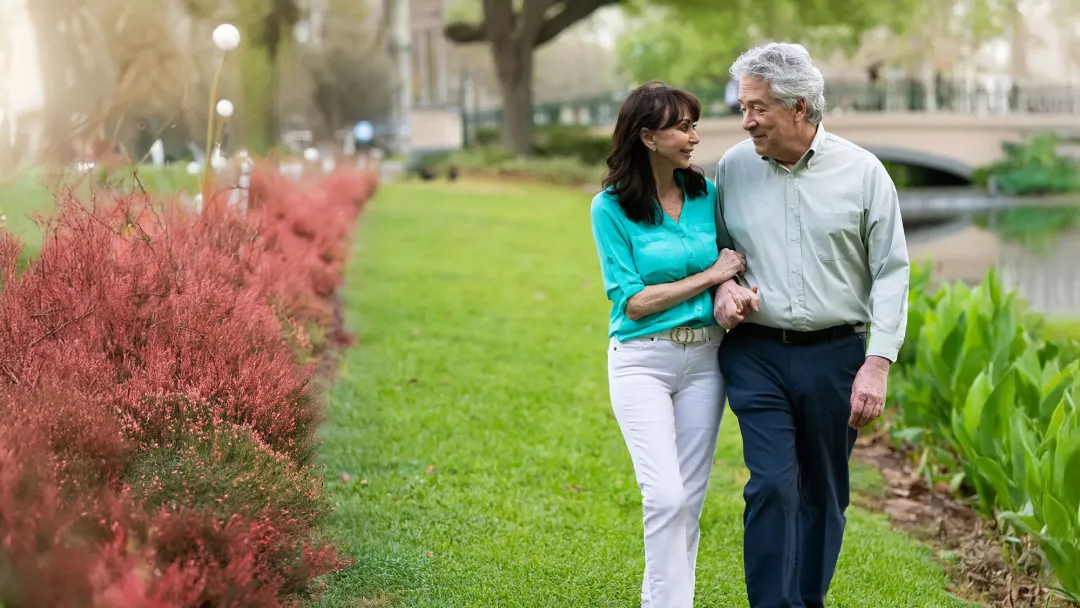 a mature couple walking outdoors
