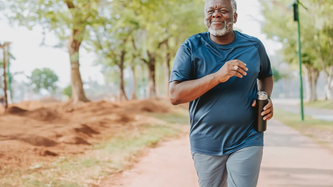 Middle aged man running in the park