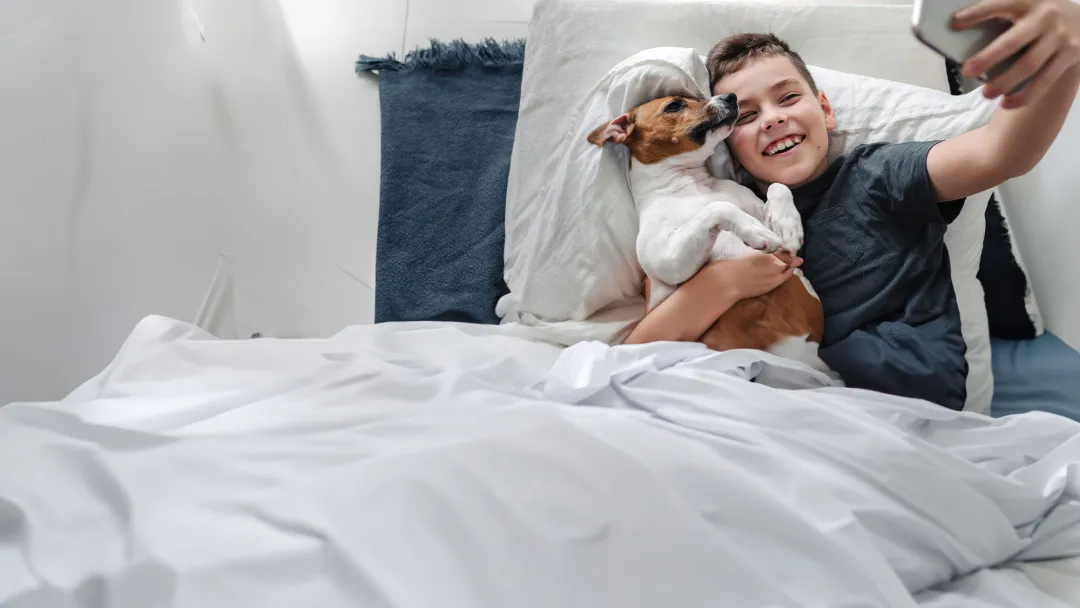 Boy Taking a Selfie with His Dog