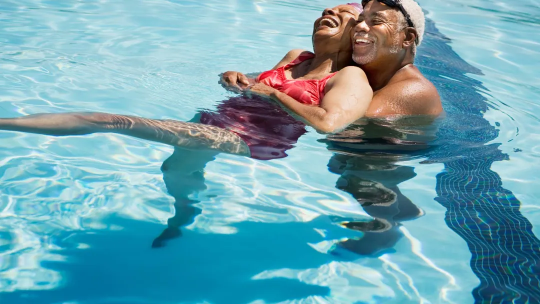 Older couple embracing in pool