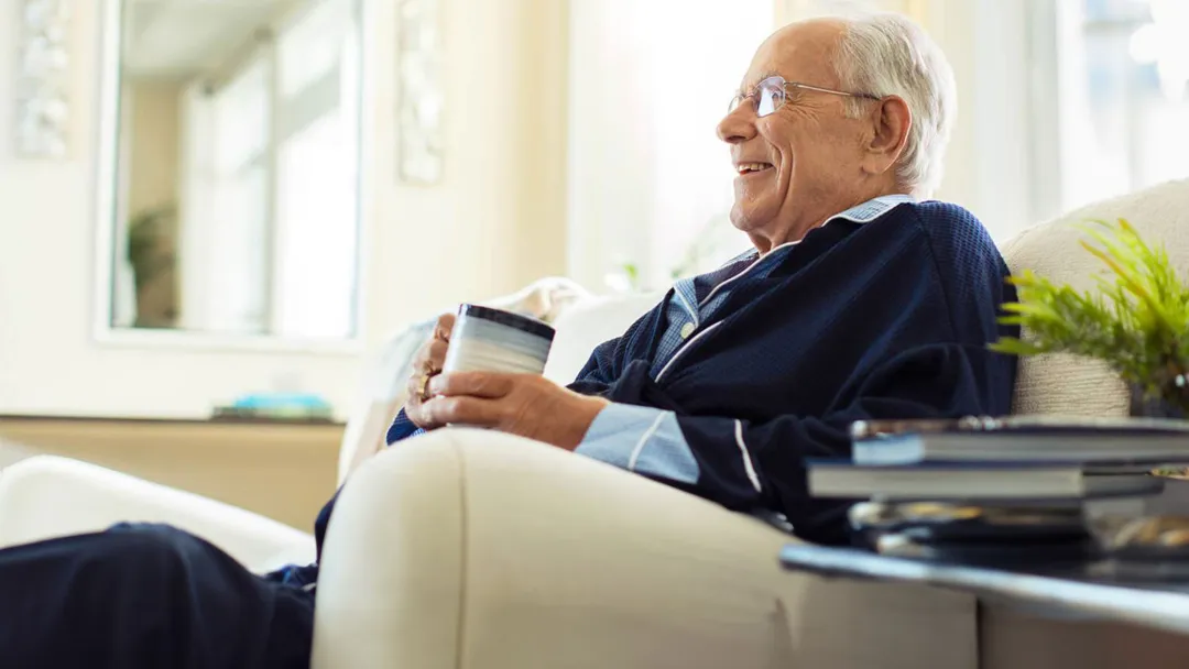 man sitting with coffee inside home