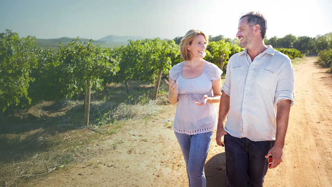 couple walking outdoors and smiling at each other