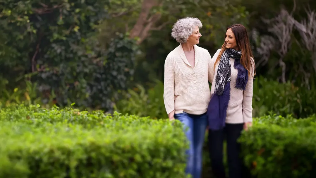 mother and daughter strolling outdoors
