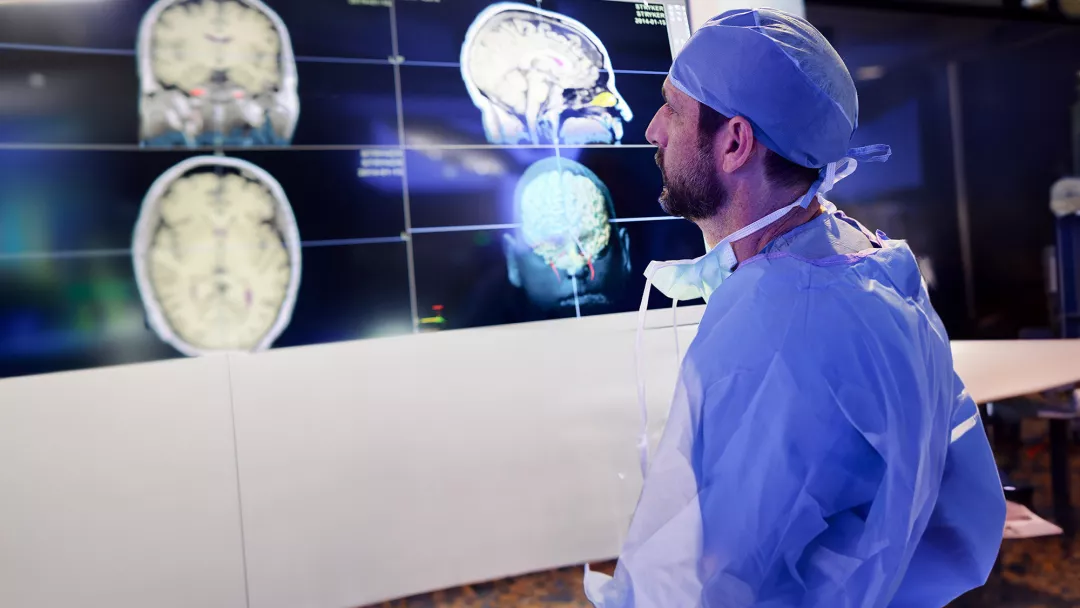 physician-looking-at-brain-scans
