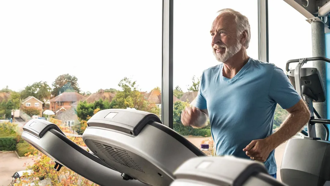 middle-aged man running on a treadmill
