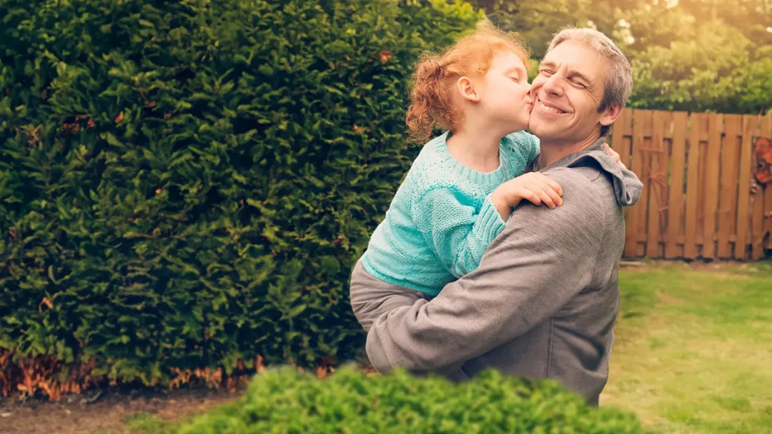 a father embracing his daughter