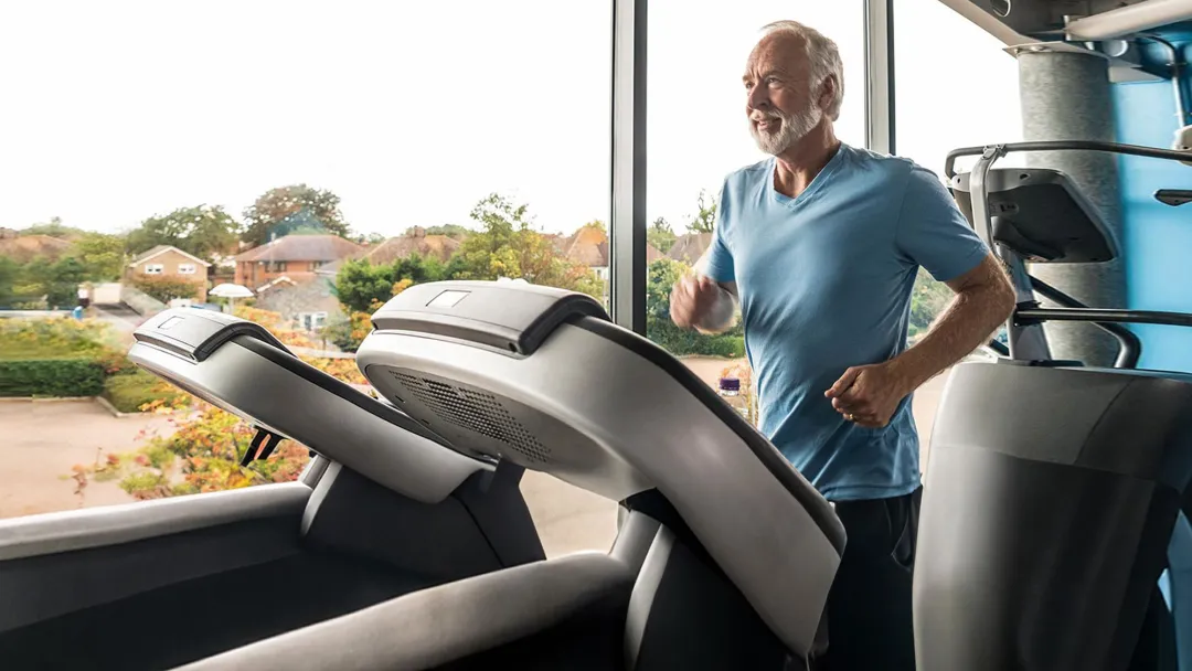 older man on treadmill at the gym