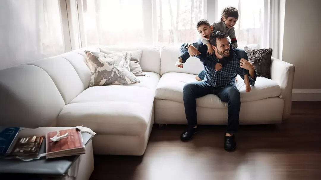 father playing with his sons indoors