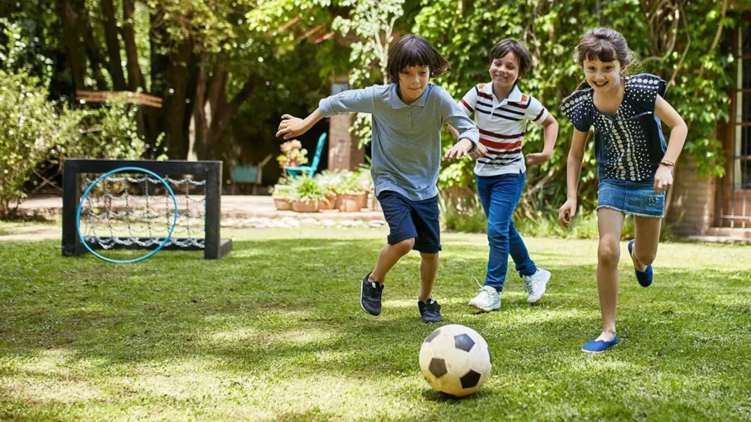 3 kids playing soccer