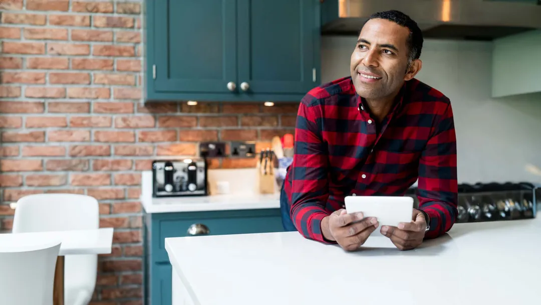Man in kitchen with tablet