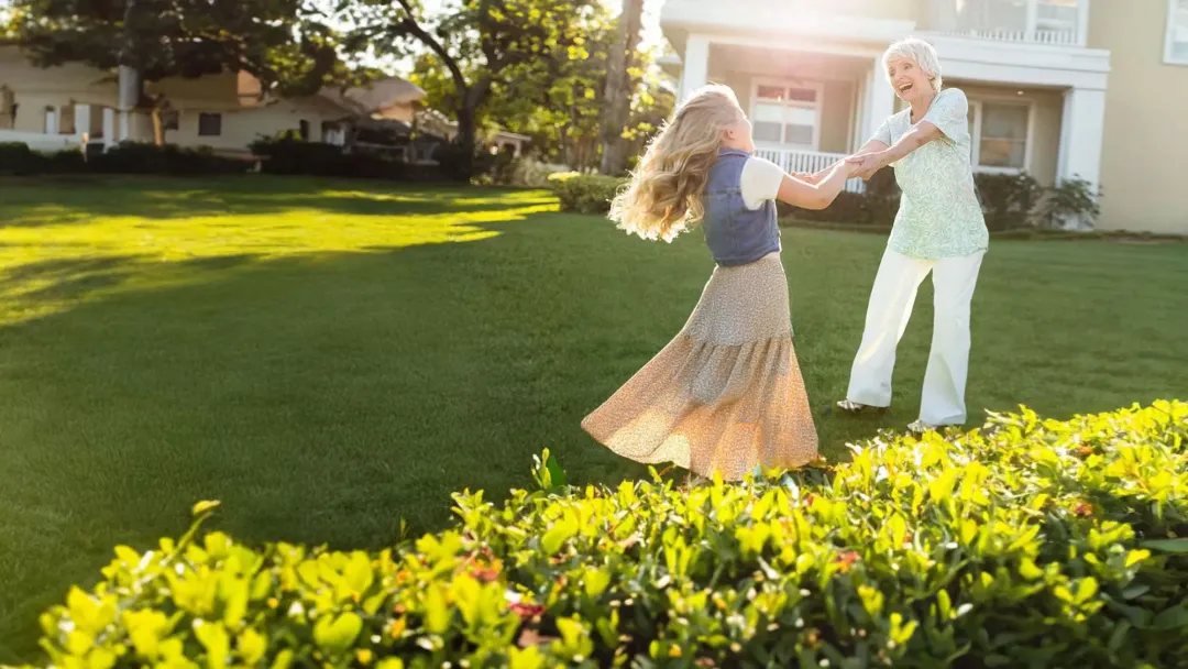 a grandmother playing with grandaughter outdoors