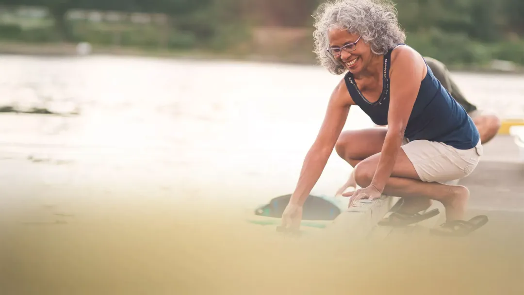 woman by the lake smiling