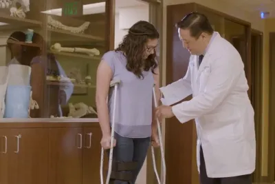 A Doctor Helps a Patient Adjust Her New Crutches