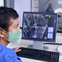 tech working with face mask in the computer