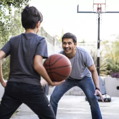 Kid and dad play basketball