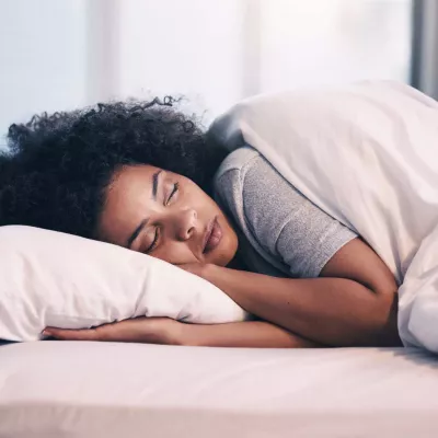 Woman sleeping in bed.