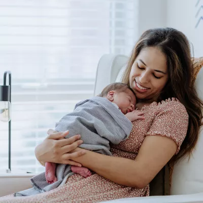 mother kisses a baby's hands peek-a-boo adventhealth gordon