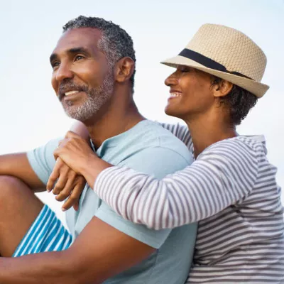 a couple outdoors embracing and smiling