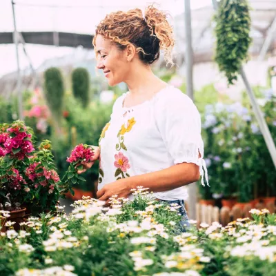 Woman enjoying flowers at garden center