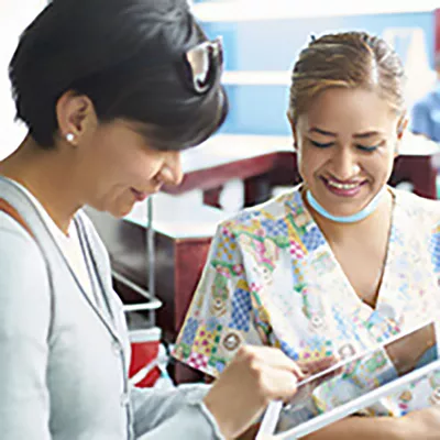 a-patient-and-a-doctor-look-at-a-tablet