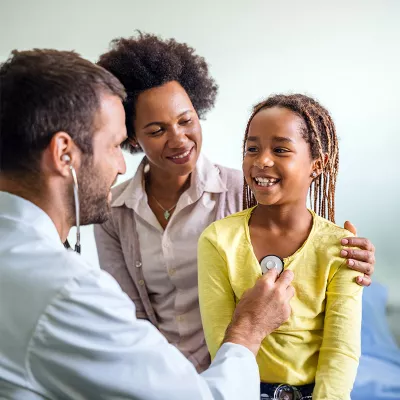 male doctor is checking girl patient heart