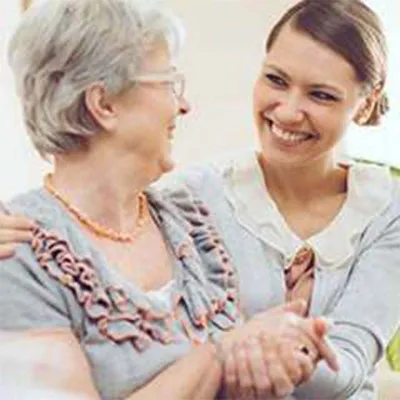 Adult daughter and mother embracing