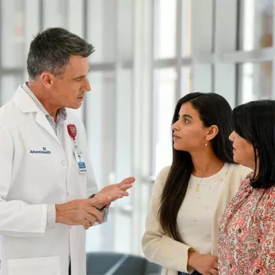 Doctor speaking with mother and adult daughter