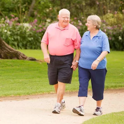 Elder couple walking in park