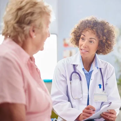 Female doctor with elderly patient