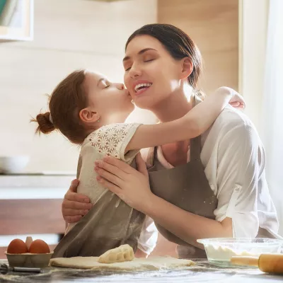 daughter kissing mom