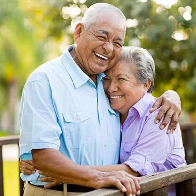 older-couple-hugging-and-laughing
