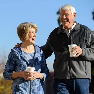 couple-drinking-coffee-and-walking
