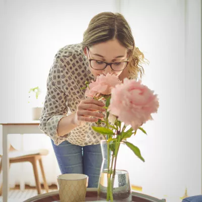 young-woman-smelling-flowers