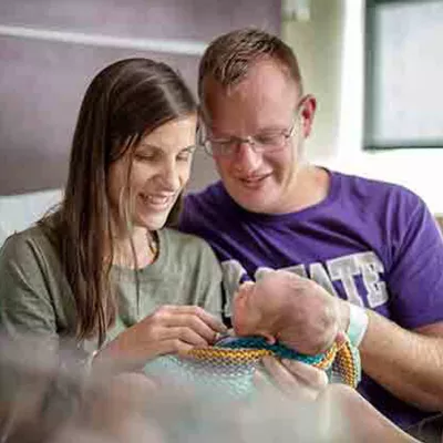 mother-and-father-looking-at-their-baby