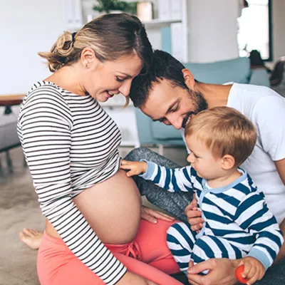 mother-showing-son-she-is-pregnant