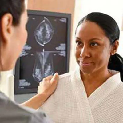 Nurse talking to female patient with scans