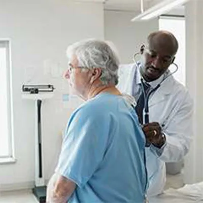 Senior man getting a checkup by male doctor