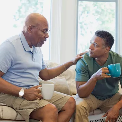 men-seating-talking-and-drinking-coffee