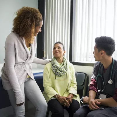 Older woman and her daughter with a nurse