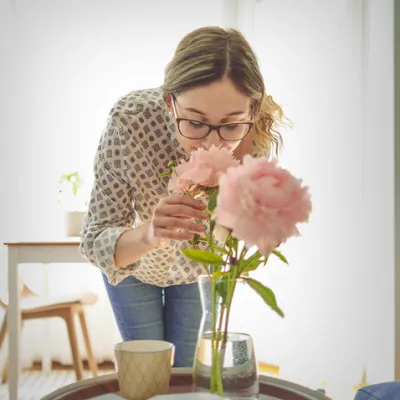 Young woman smelling flowers