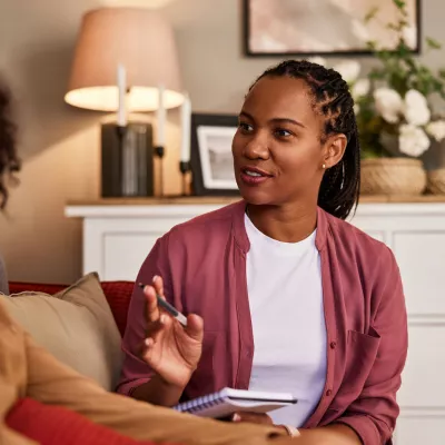Mental health provider speaking to young client.