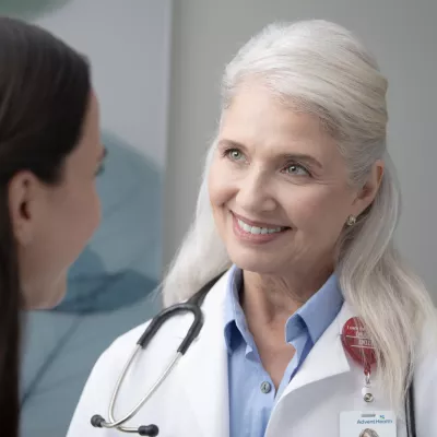 A Doctor Listens to Her Patient in a Women's Clinical Exam Room