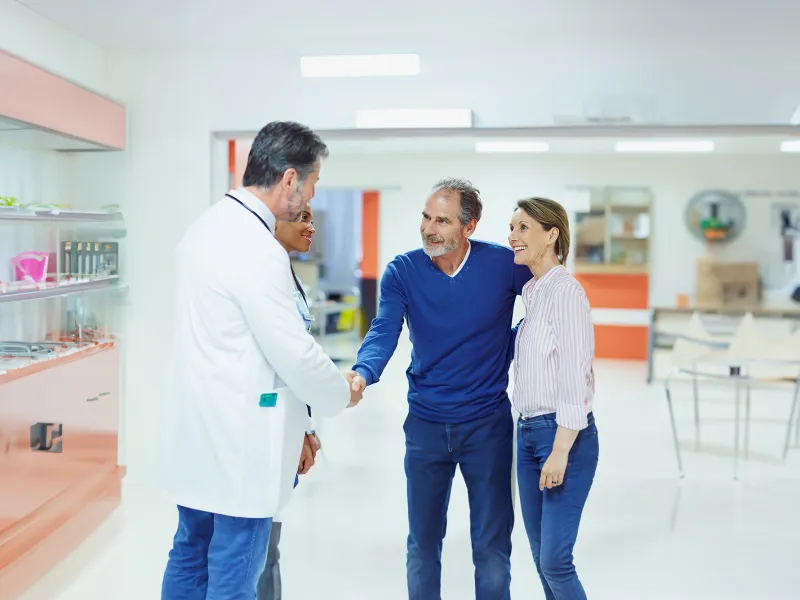 lp-50-50-digestive-colorectal-west-a-mature-couple-shaking-hands-with-doctors