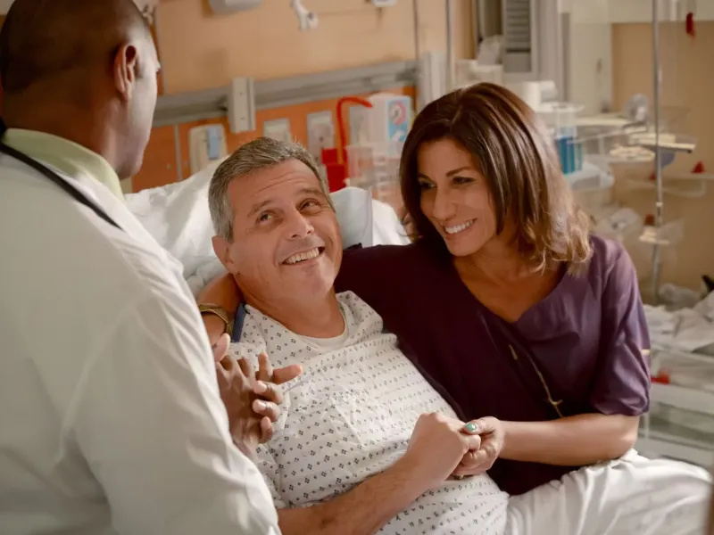 man-smiling-at-doctor-with-wife