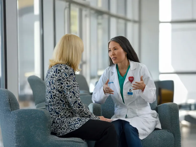 A middle-aged woman talks to a provider