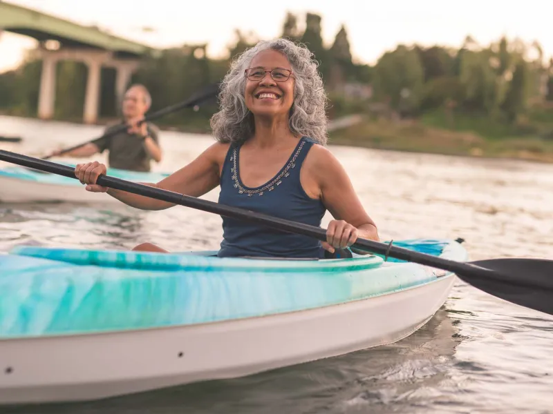 Old woman in glasses kayaking