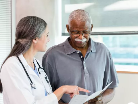 A Physician Goes Over a Chart with a Patient