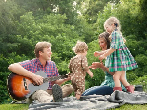A dad's musical day in the park with his family.