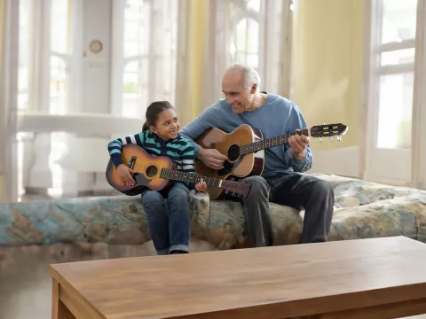 grandfather-playing-guitar-with-his-grandaughter