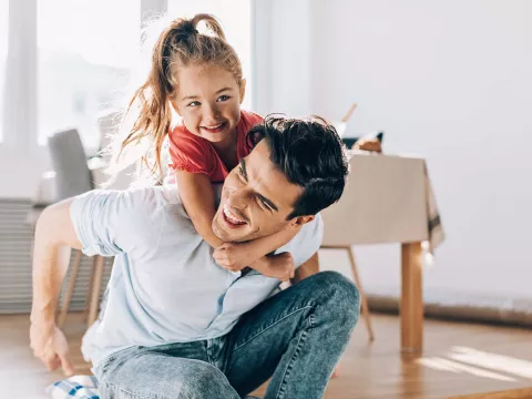 Father playing with his little girl at home